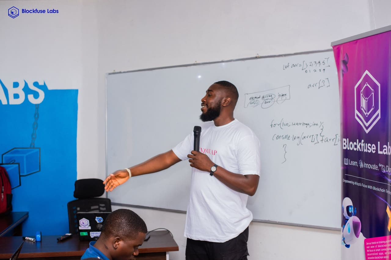 Emmanuel at a whiteboard explaining code